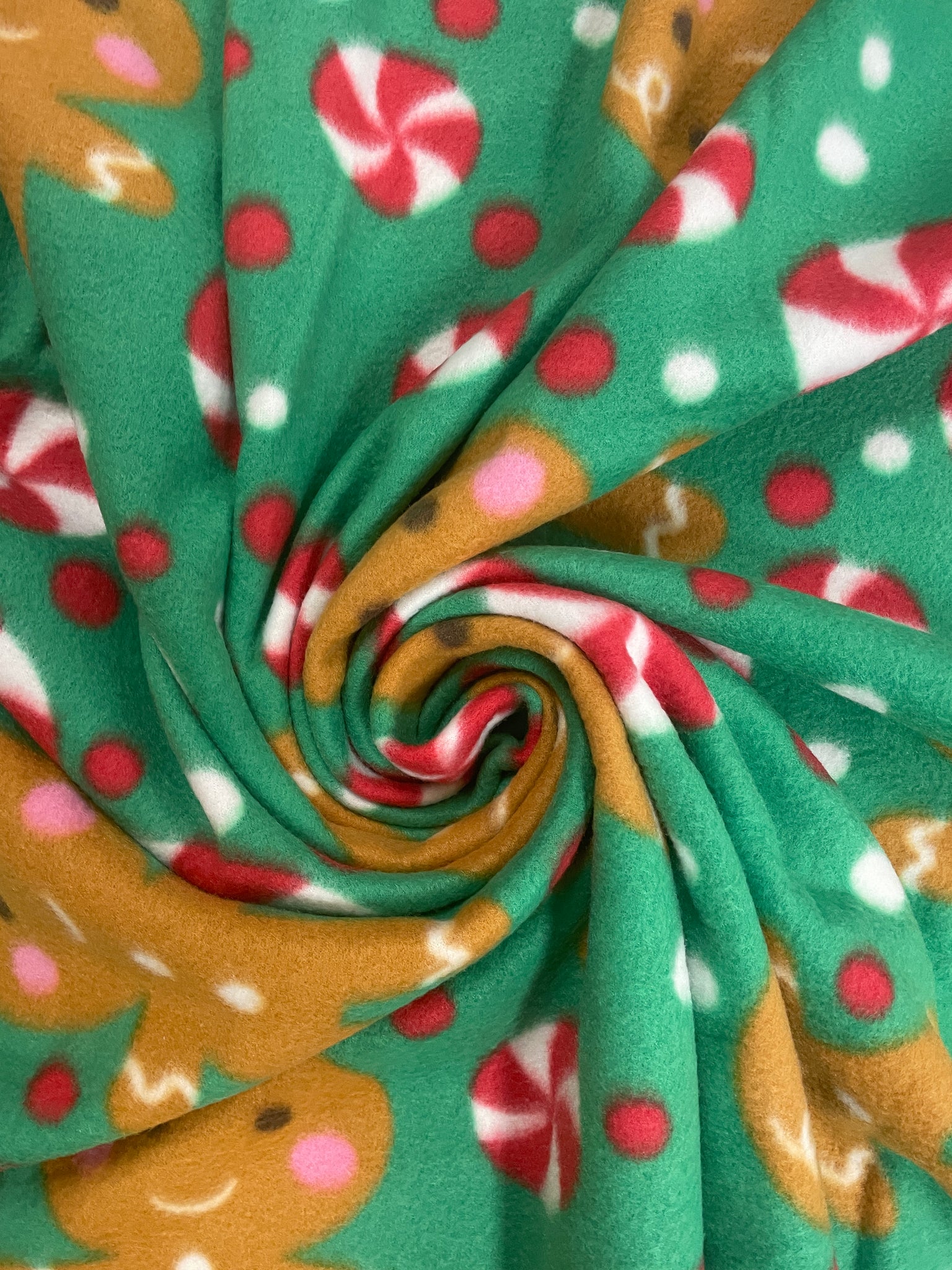 1 1/3 YD Polyester Polar Fleece - Gingerbread and Peppermints on Green Background