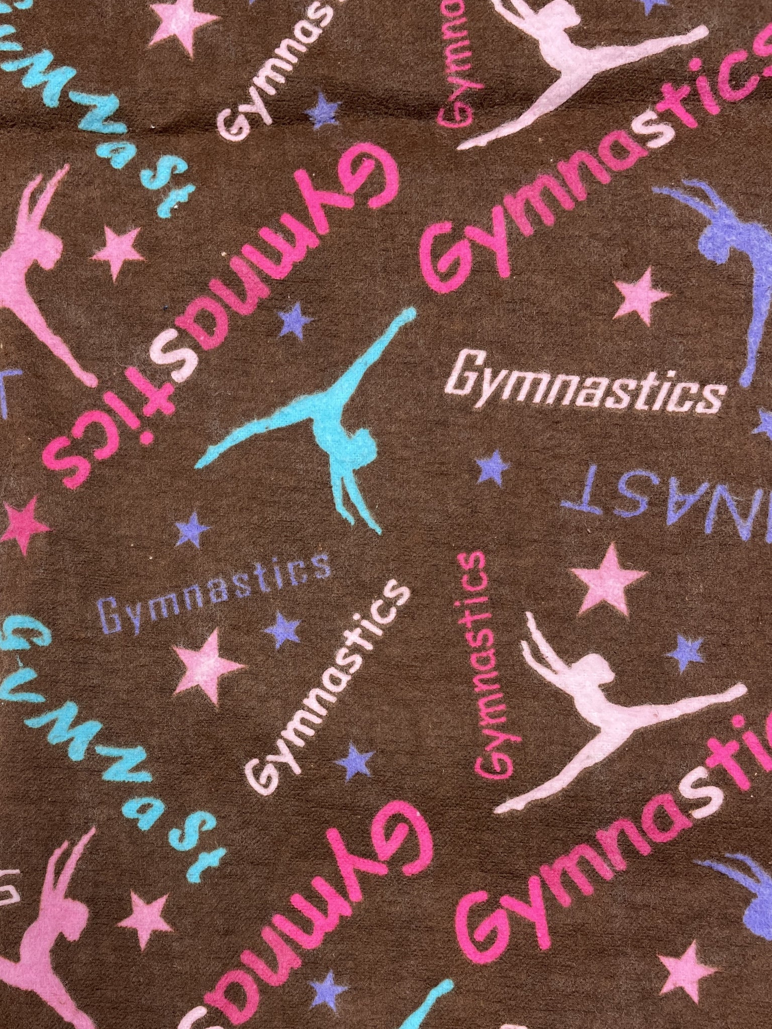 2 YD Cotton Flannel - Brown with Gymnastic Graphics